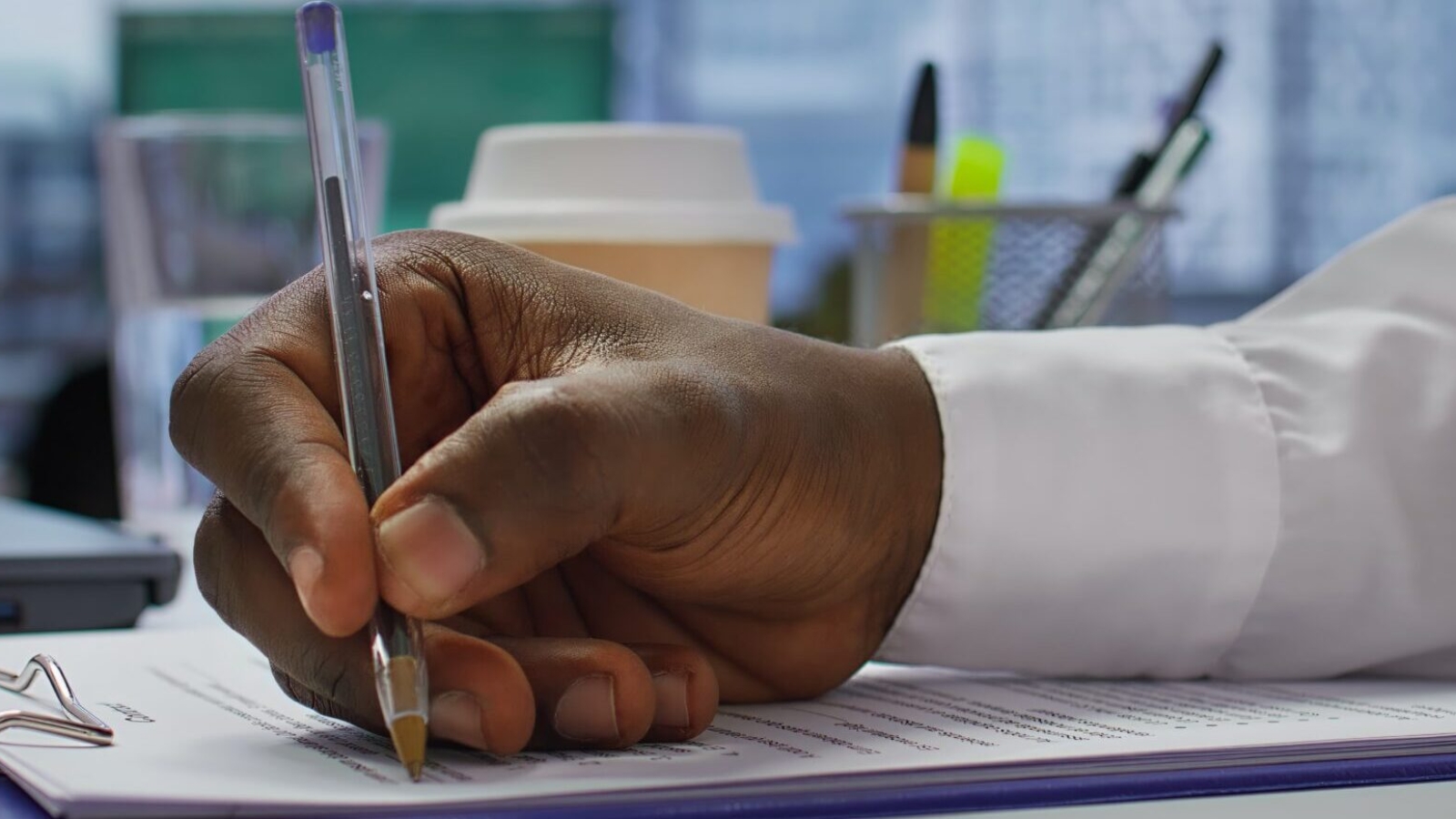Job candidate signing his work contract and securing a corporate position, reading the employment agreement terms. Businessman applicant finding a new job within company. Close up. Camera B.