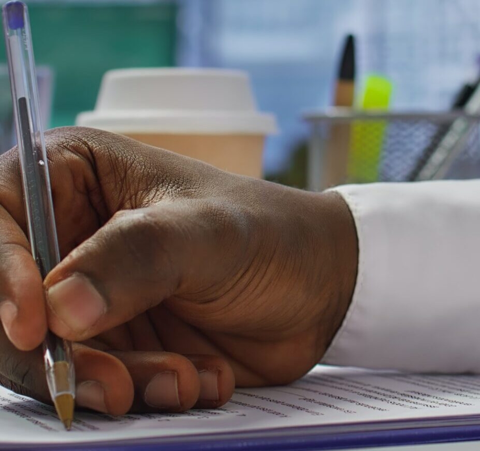 Job candidate signing his work contract and securing a corporate position, reading the employment agreement terms. Businessman applicant finding a new job within company. Close up. Camera B.